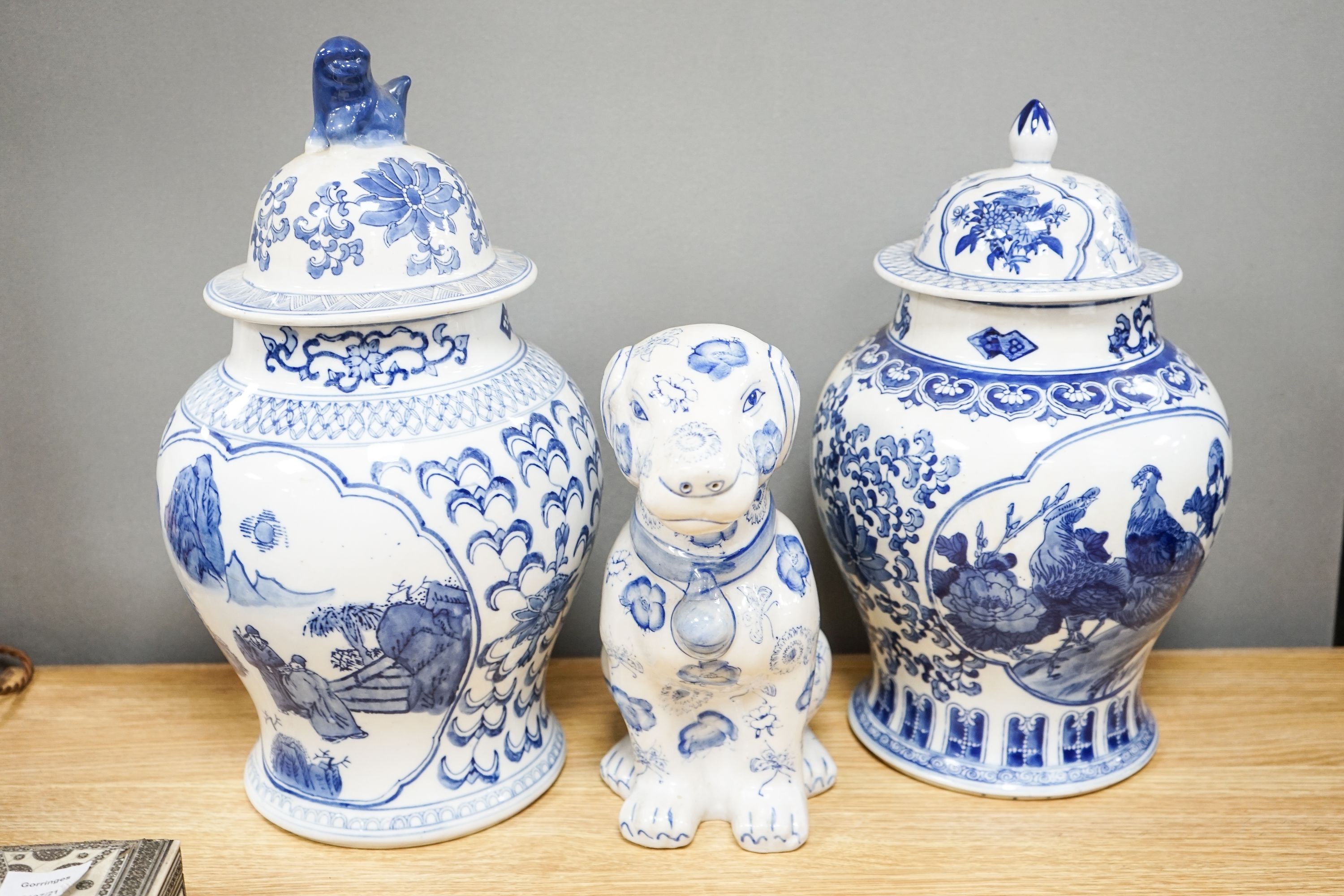 2 modern Chinese blue and white vases and covers and a similar model of a dog.